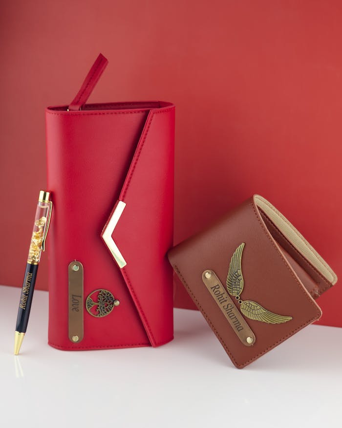 our-experience Elegant red leather portfolio and brown wallet with bespoke metal accents.