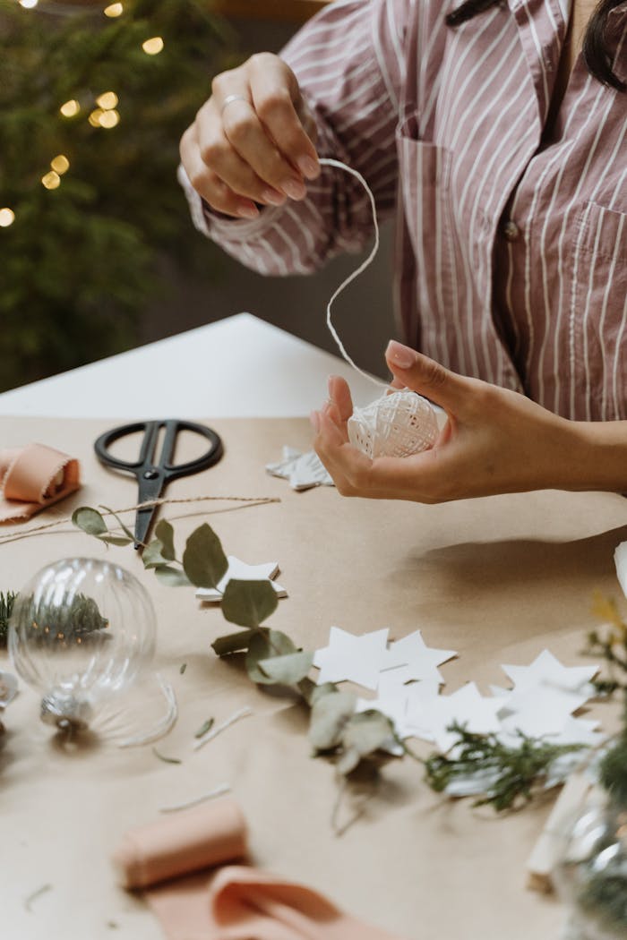 our-services-1 Handcrafting Christmas ornaments with paper stars and greenery.